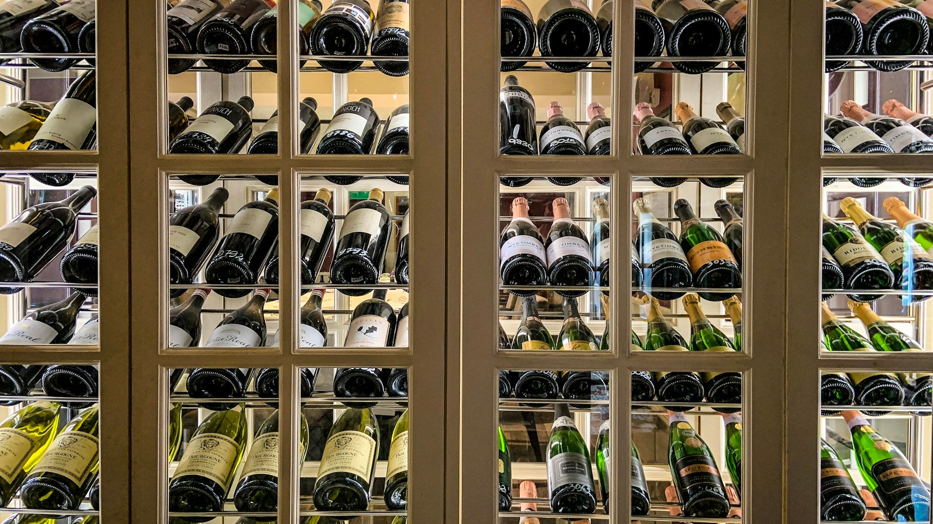 Wine bottles in a warm wooden cabinet